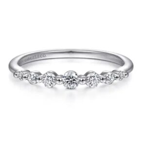14 karat white gold diamond stackable fashion ring by Gabriel & Co. features .26 carat total weight of round diamonds.