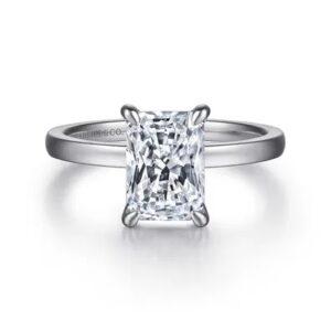 This 14 karat white gold engagement ring by Gabriel & Co. features one 2CT radiant center diamond.
